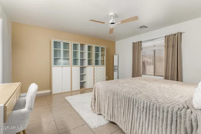 a bedroom with a large bed and a window