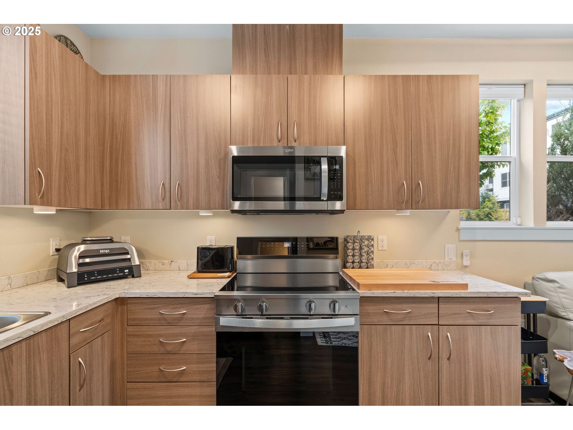 116 Northeast 109th Avenue, Unit A5 Portland, OR 97220 - Photo 17 of 46 a kitchen with a sink a stove a microwave cabinets and a window