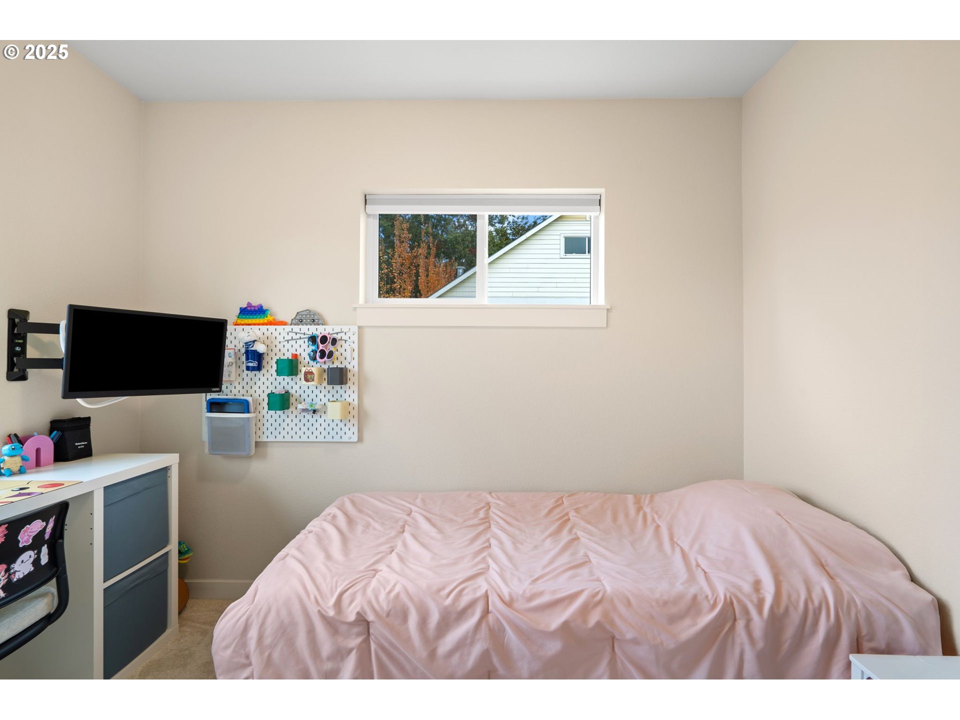 116 Northeast 109th Avenue, Unit A5 Portland, OR 97220 - Photo 35 of 46 a bedroom with a bed and a flat screen tv