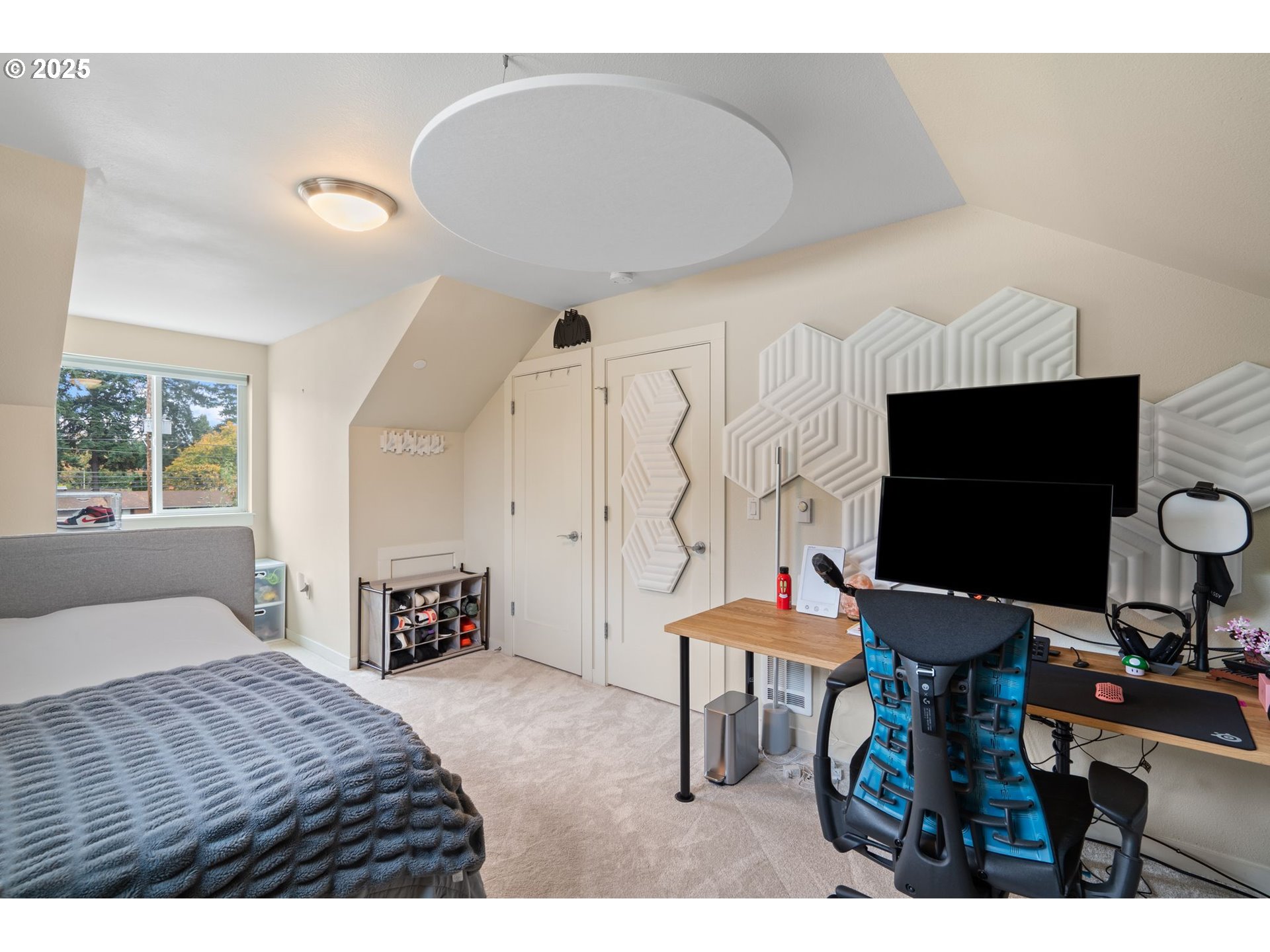 116 Northeast 109th Avenue, Unit A5 Portland, OR 97220 - Photo 40 of 46 a bedroom with furniture and a flat screen tv