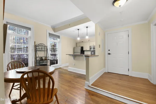 a view of a dining room with furniture and wooden floor