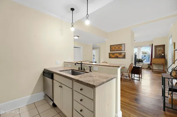 a view of living room with granite countertop furniture and wooden floor