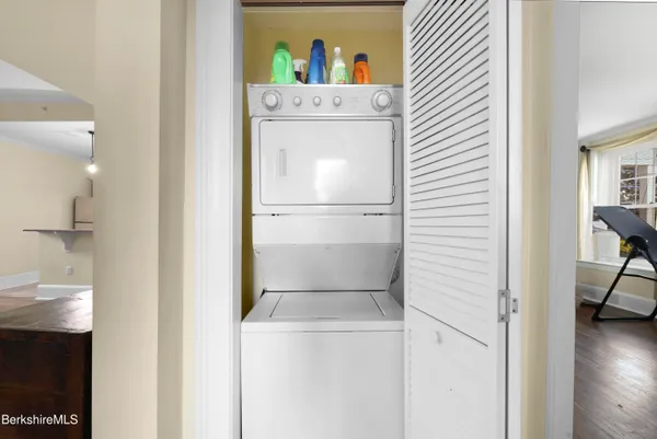 a white refrigerator freezer and a stove sitting inside of a kitchen
