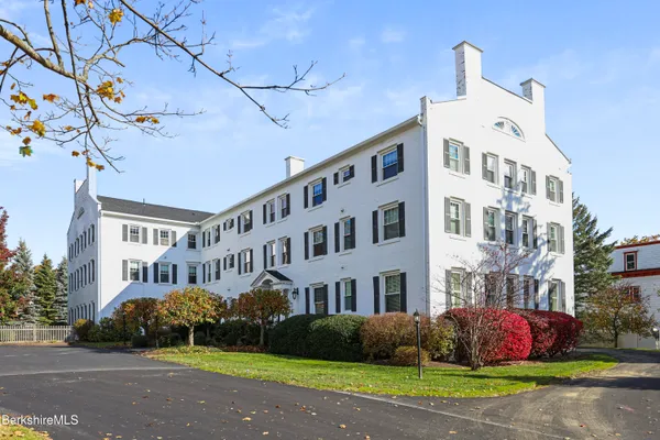 a front view of a building with garden