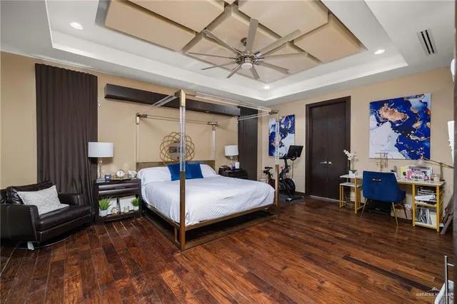 a bedroom with furniture and wooden floor