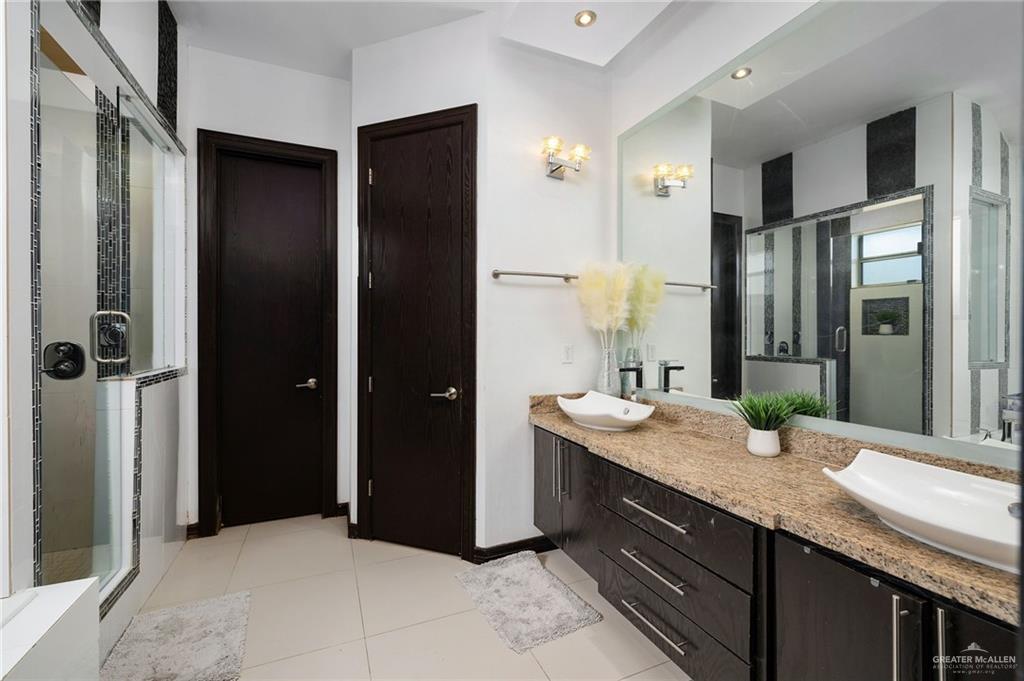3011 Rio San Juan Street Rio Grande City, TX 78582 - Photo 14 of 31 a bathroom with a granite countertop sink and a mirror
