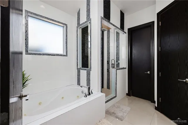 a bathroom with a bathtub and a shower