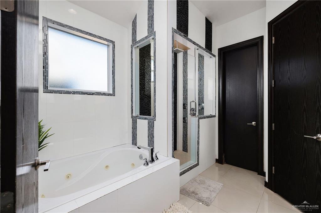 3011 Rio San Juan Street Rio Grande City, TX 78582 - Photo 15 of 31 a bathroom with a bathtub and a shower