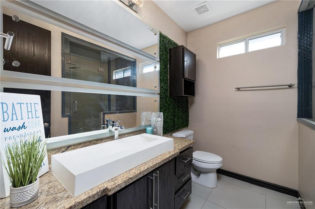 3011 Rio San Juan Street Rio Grande City, TX 78582 - Photo 18 of 31 a bathroom with a sink a toilet and shower