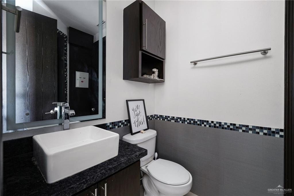 3011 Rio San Juan Street Rio Grande City, TX 78582 - Photo 20 of 31 a bathroom with a sink a toilet and mirror
