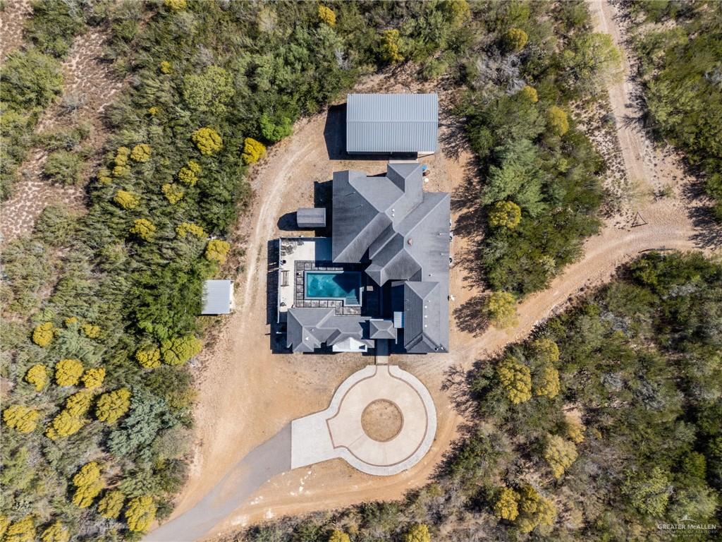 3011 Rio San Juan Street Rio Grande City, TX 78582 - Photo 3 of 31 an aerial view of a house with garden space and trees all around