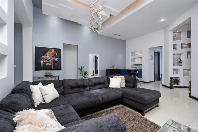 a living room with furniture and a chandelier