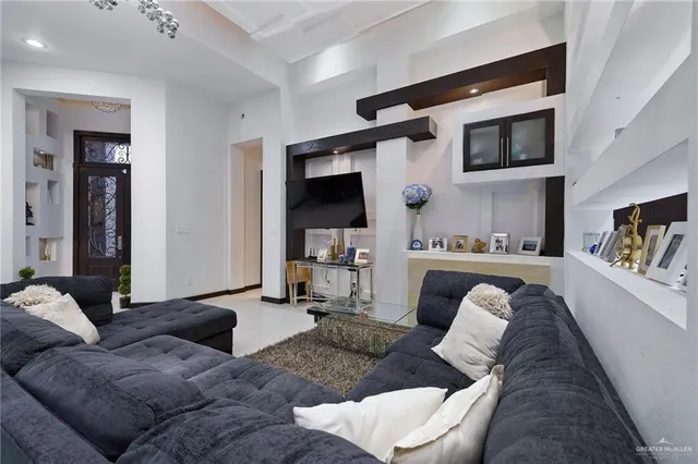 a living room with furniture and a flat screen tv