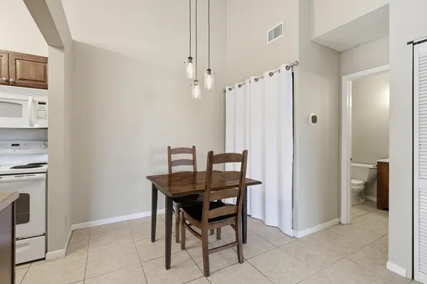 a dining room with furniture and window