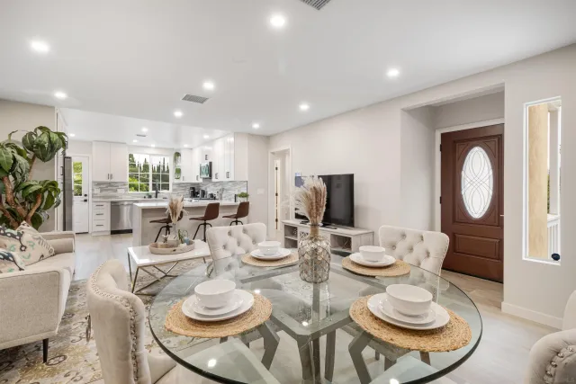 a dining room with furniture a rug and a fireplace