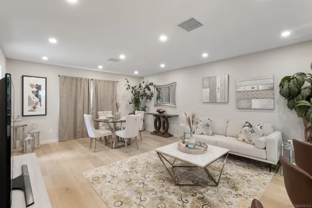 a living room with furniture a rug and a table