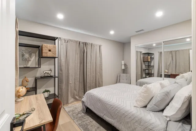 a bedroom with a bed and a mirror