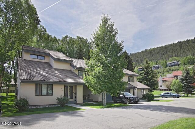 264 Eagle Drive, Unit 206 Eagle-Vail, CO 81620 - Photo 1 of 12 a front view of a house with a yard and a garage