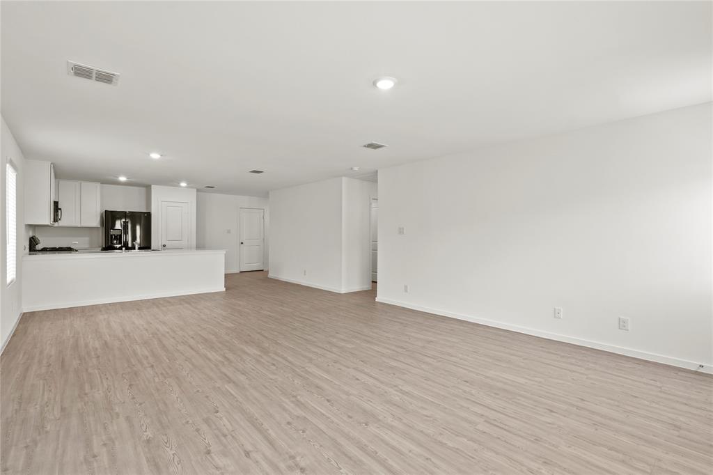 1138 Barbary Flds Street Forney, TX 75126 - Photo 4 of 19 a view of a kitchen with a sink and a refrigerator