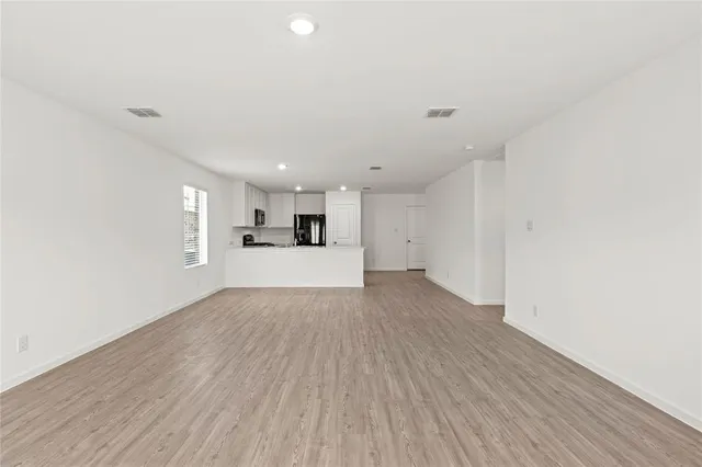 a view of a kitchen with a sink and a refrigerator