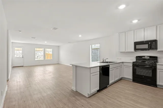 a kitchen with a stove top oven and sink