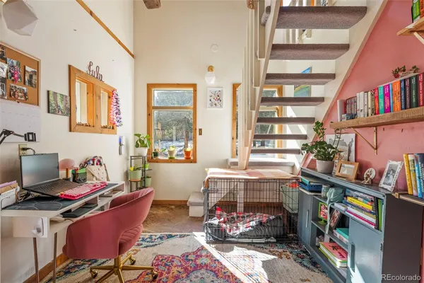 a bedroom with furniture and a book shelf