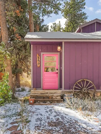 a front view of a house with a yard covered with snow