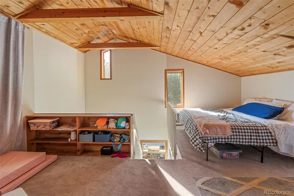 a spacious bedroom with a bed and a table