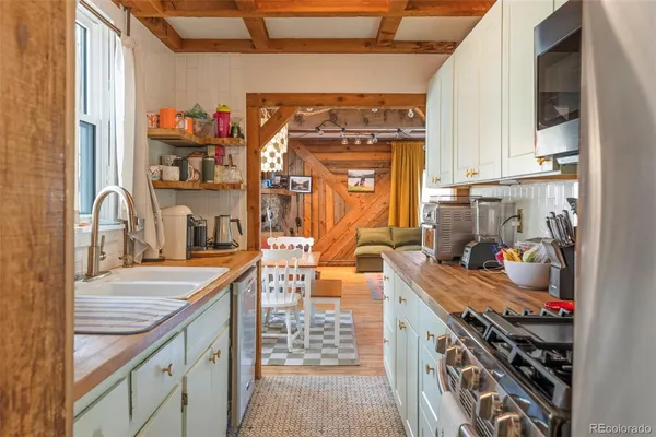 a kitchen with stainless steel appliances granite countertop a sink stove and cabinets