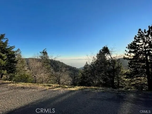 a view of dirt road with a building in the background