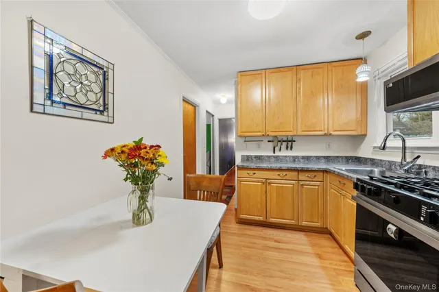 a kitchen with a refrigerator and white cabinets