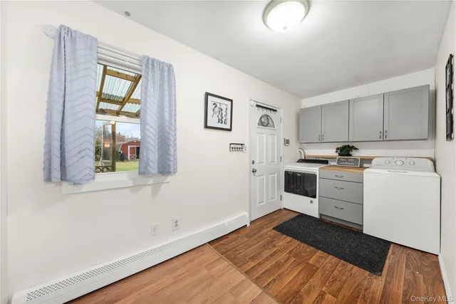 a bathroom with a sink a toilet and a window