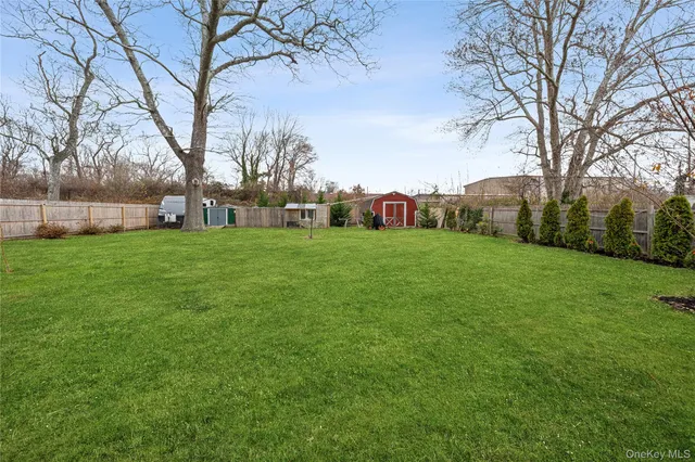 a front view of a house with a large garden