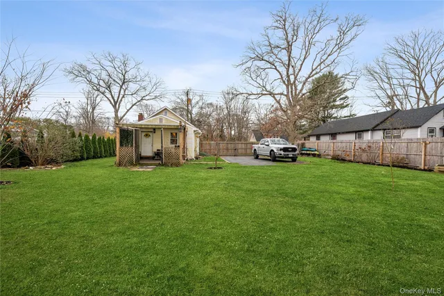 a view of a house with a yard and tree s