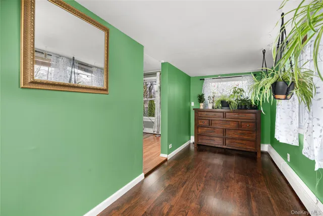 a view of room with window and wooden floor