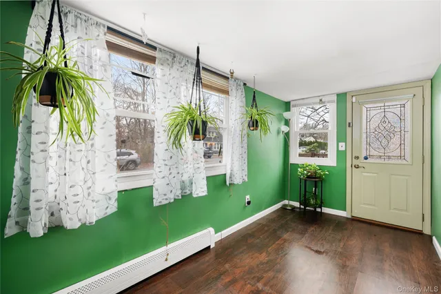 a living room with furniture a flat screen tv and a floor to ceiling window
