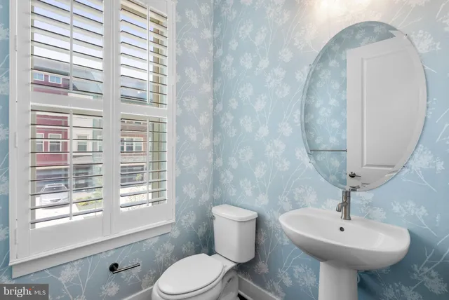 a view of a big room with wooden floor and windows