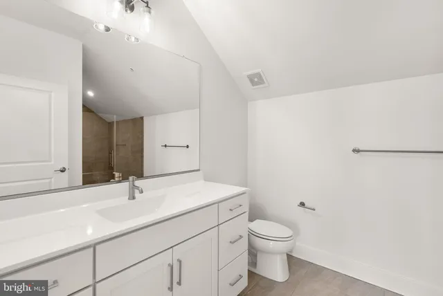 a roof deck with table and chairs