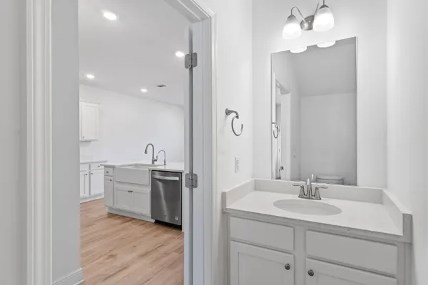 a bathroom with a sink vanity granite tub and shower