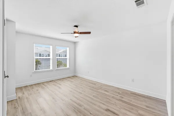 wooden floor in an empty room with a window