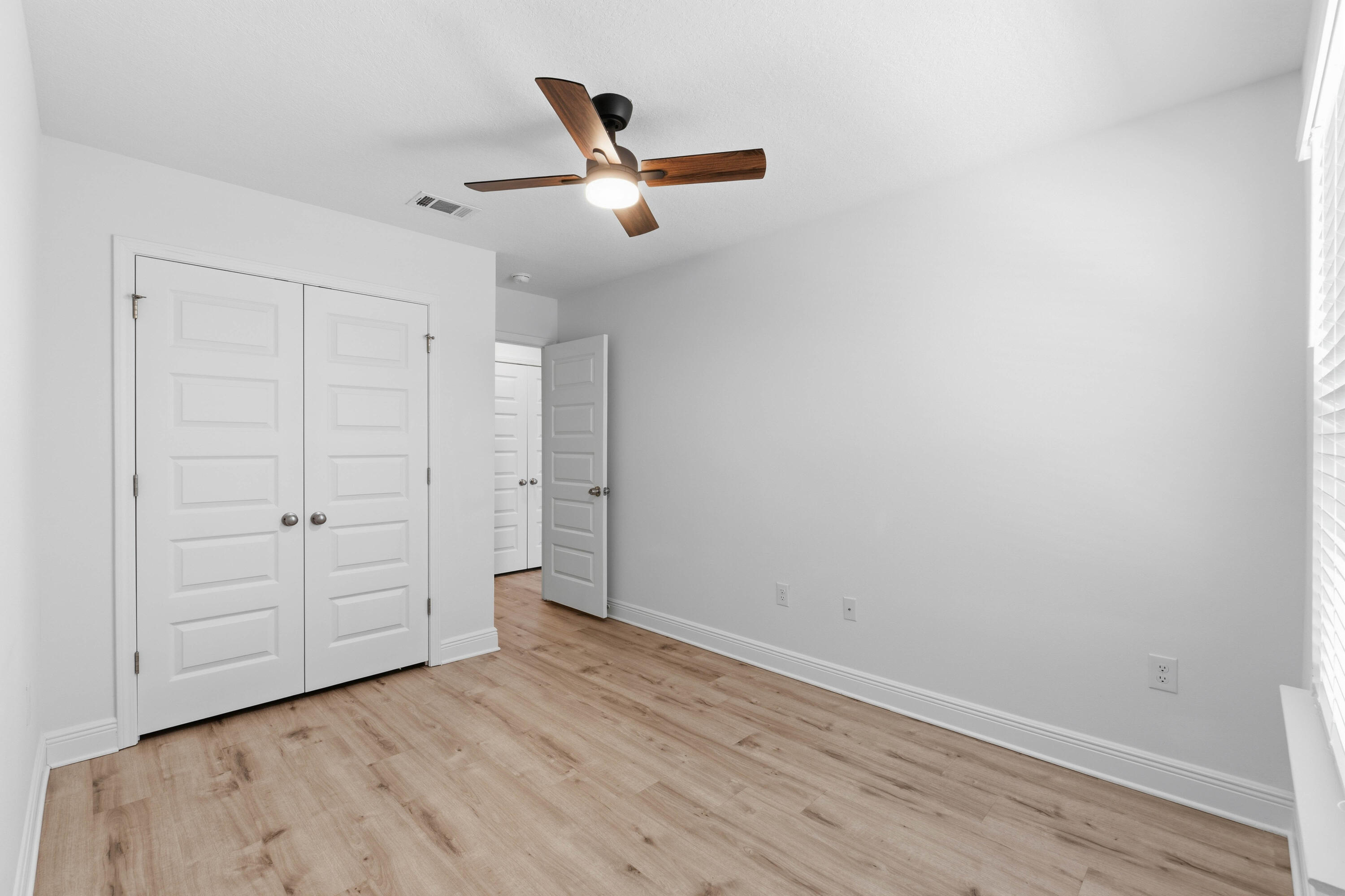 7 Renea Cove Destin, FL 32541 - Photo 19 of 36 an empty room with wooden floor cabinet and windows