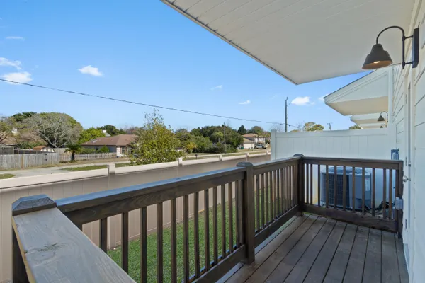 a view of balcony with wooden floor