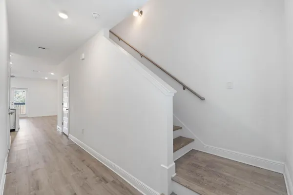 a view of an entryway with wooden floor