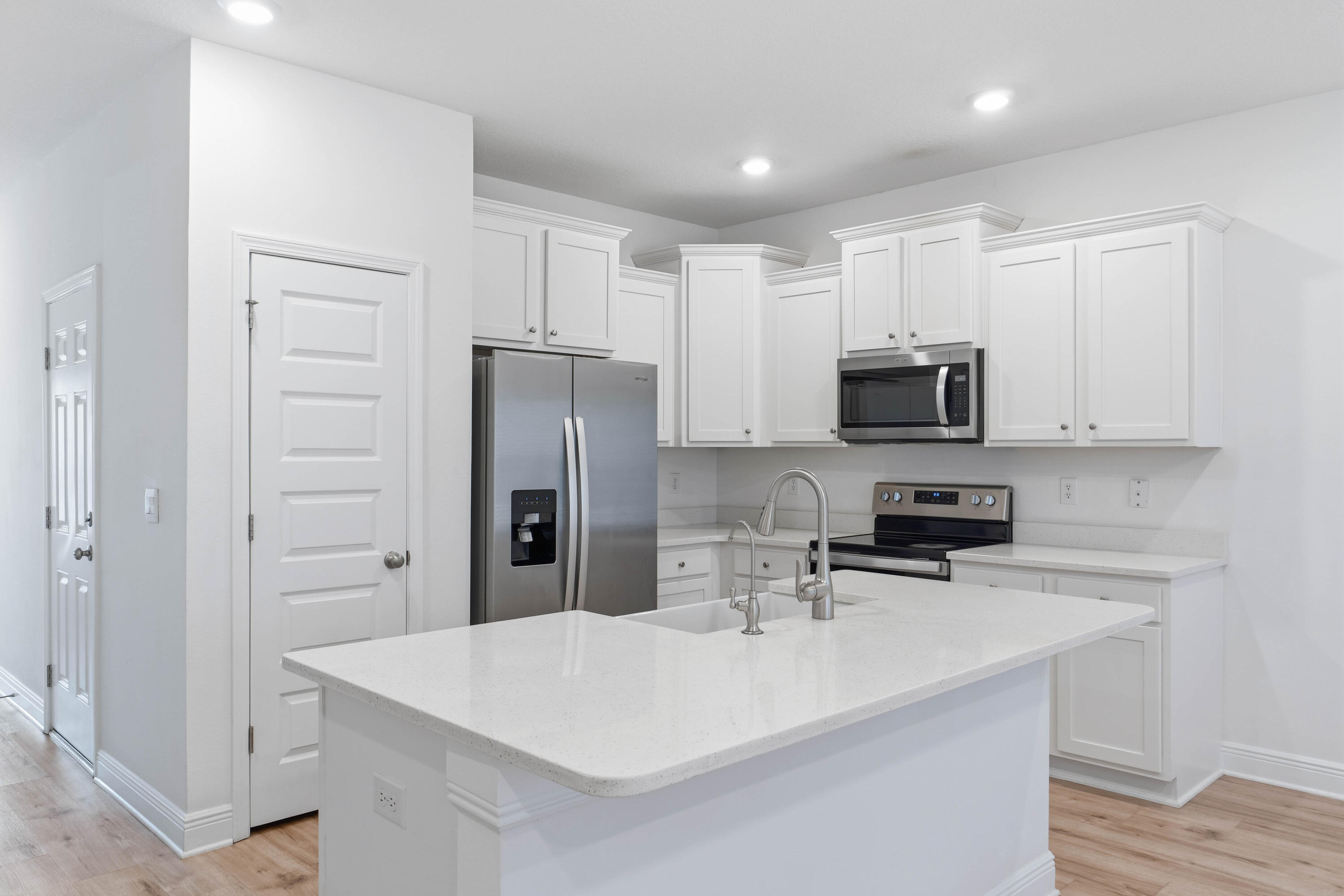 7 Renea Cove Destin, FL 32541 - Photo 7 of 36 a kitchen with kitchen island a sink appliances and cabinets