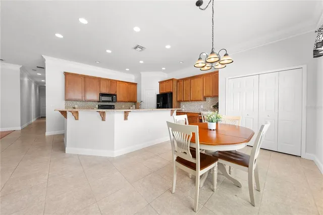 a kitchen with stainless steel appliances granite countertop sink stove and refrigerator