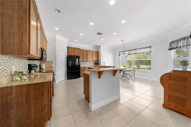 a view of a dining room with furniture and a chandelier