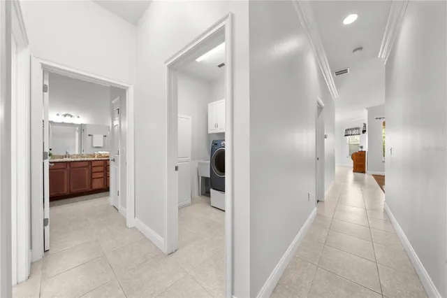 a spacious bathroom with a tub sink and mirror