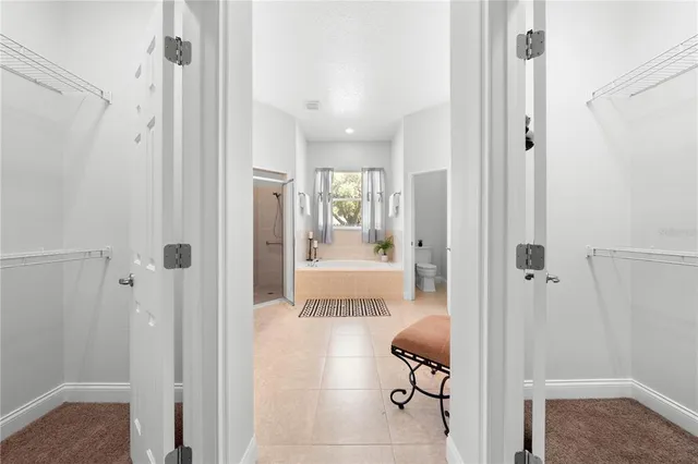 a view of a house with a yard and potted plants