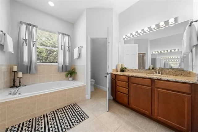 a front view of a house with a yard and potted plants
