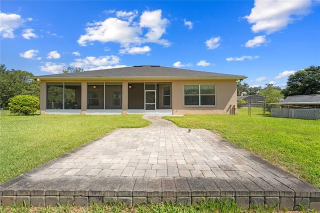 an aerial view of residential houses with yard